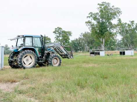 Tractor towing pig shed