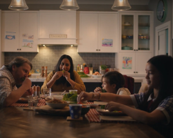 Screenshot of Australian Pork san choy bow TV commercial. Family of 4 sitting around dinner table eating pork san choy bow.