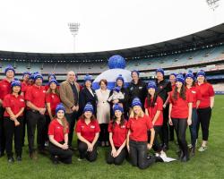 Coles and APL staff wearing fight MND beanies. 