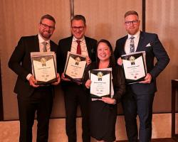 APL staff member with AMIC winners 